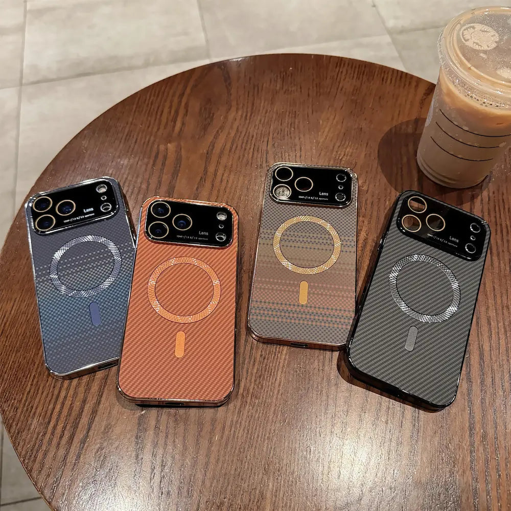 Four gradient carbon fiber magnetic Phone cases laid flat on wooden table, electroplated metal frame, full built-in glass camera lens cover, magnetic wireless charging hard case