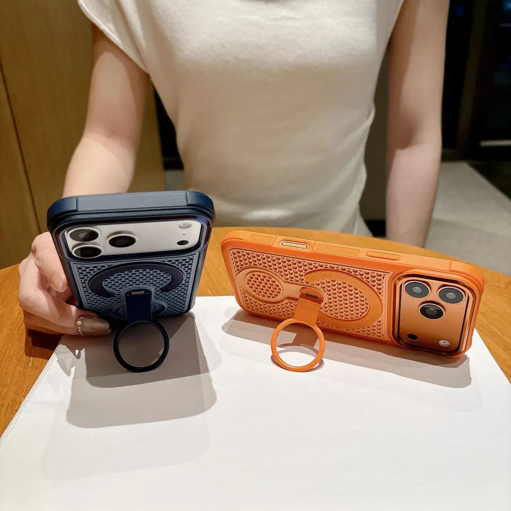 Two textured phone cases with unfolded finger ring stand placed on wooden desktop